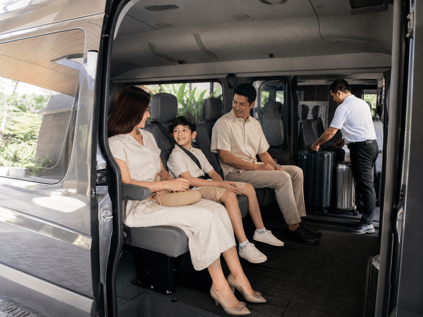 Family seated comfortably inside a private passenger van